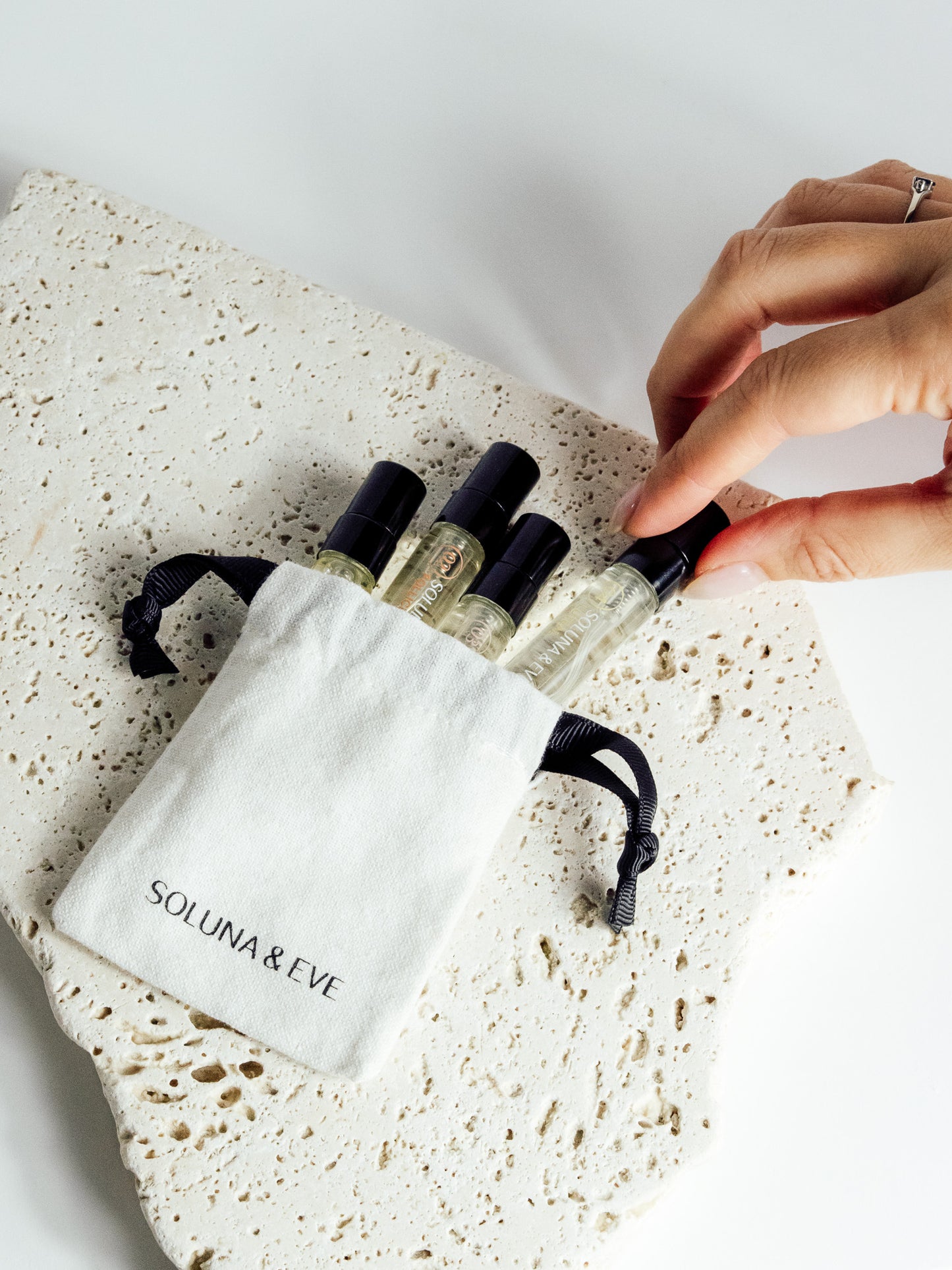 Mini ritual bag to carry cycle-syncing perfumes on the go